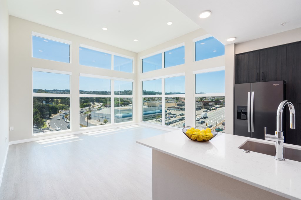a kitchen with a sink and a large amount of windows