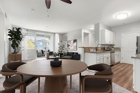 A modern dining room with a round table and chairs.