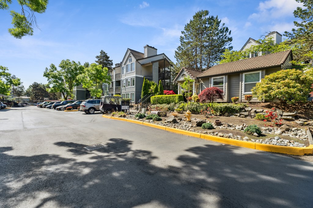 the view of a street with houses and cars parked in front of them