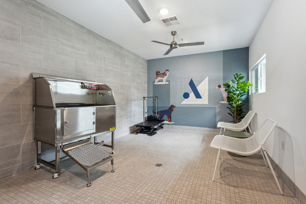 a patient room with a refrigerator and a chair and a plant