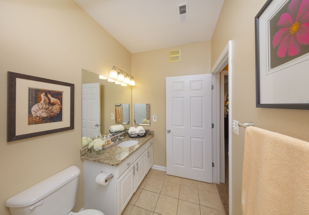 A bathroom with a white tub and sink.