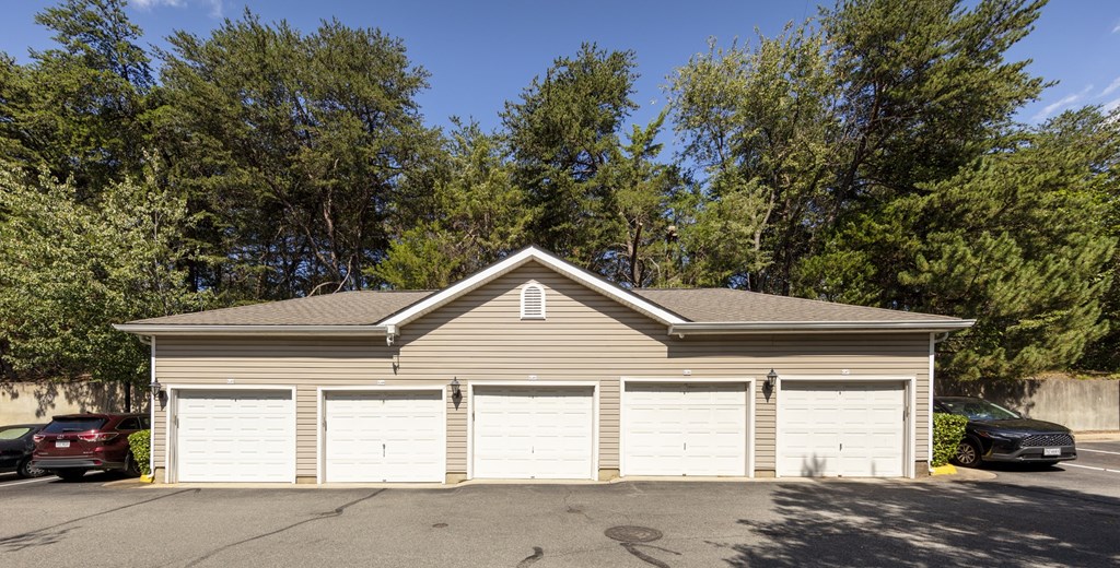 A two-car garage with a brown roof and white garage doors.