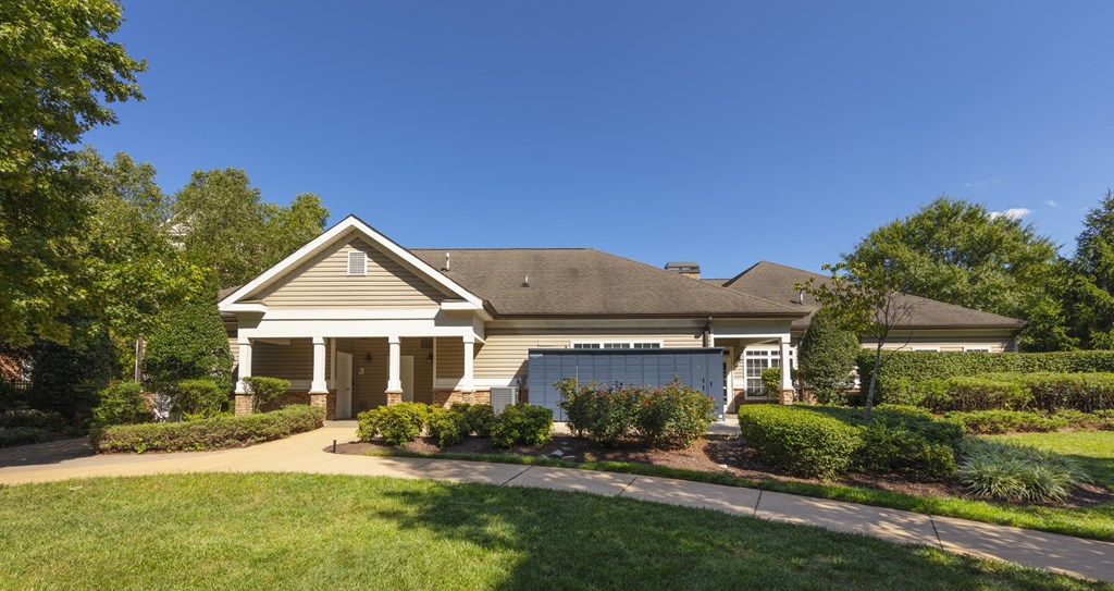 A house with a grey roof and a white garage door.