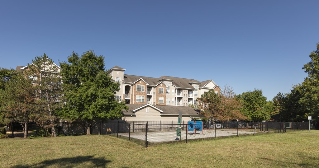 A large apartment complex with a playground in front.