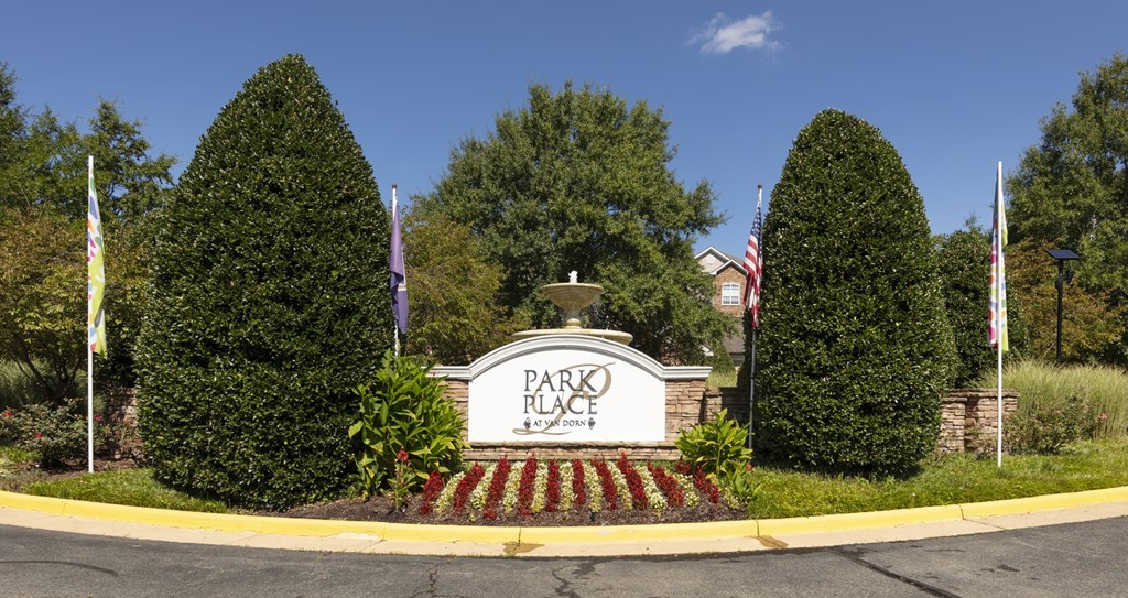 The entrance to Park Place is marked by a sign and two large trees.
