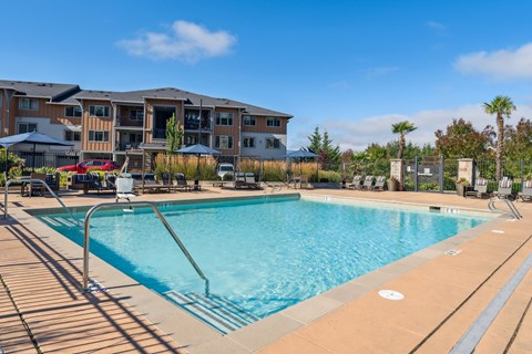 a swimming pool with a building in the background