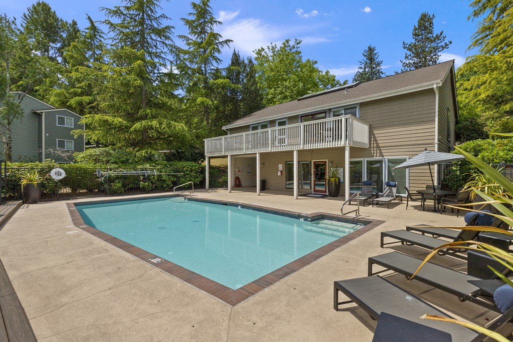 a swimming pool with a house in the background
