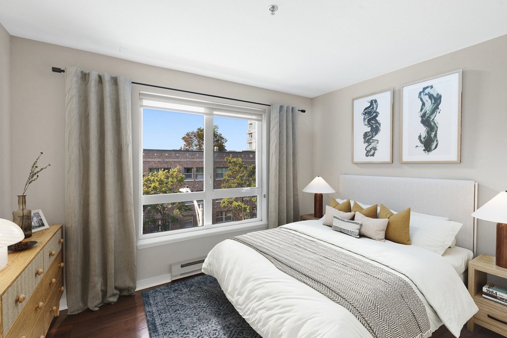 a bedroom with a large bed and a large window