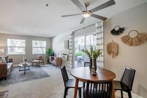 A living room with a dining table and chairs.