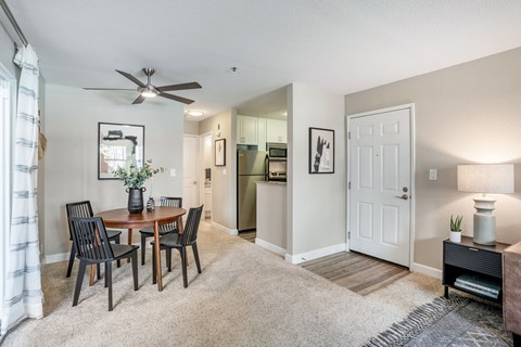 A dining room with a table set for four.