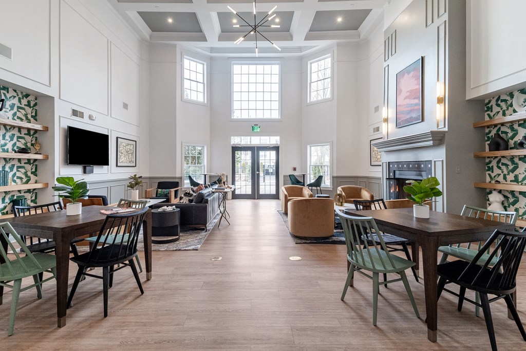 a large living room with tables and chairs and a fireplace