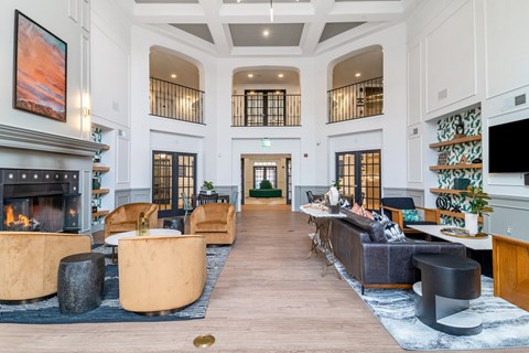 a large living room with couches and a fireplace