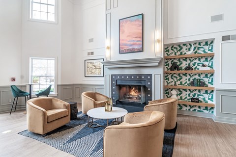a living room with chairs and a fireplace