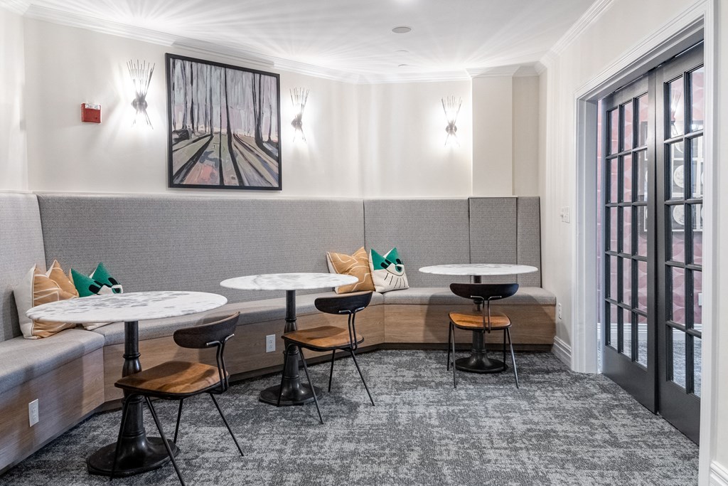 a lounge area with tables and chairs and a couch