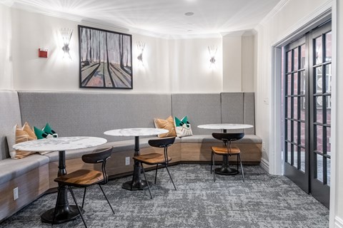 a lounge area with tables and chairs and a couch