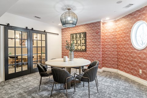 a conference room with a round table and chairs