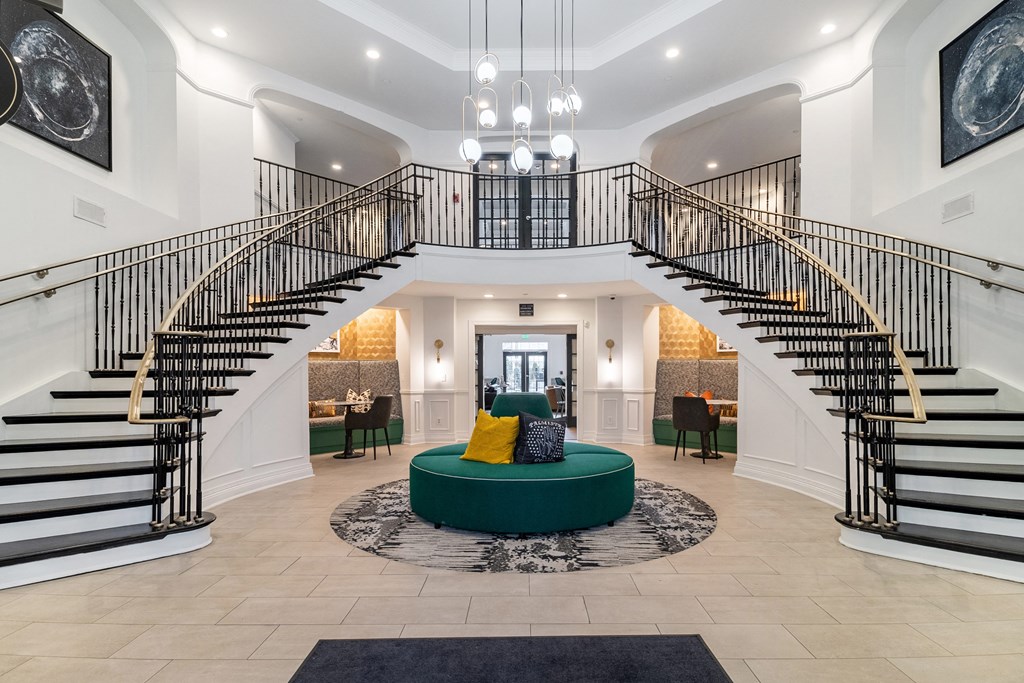 a living room with a spiral staircase and a green couch