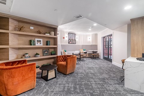 a living room with couches and chairs and a table with chairs