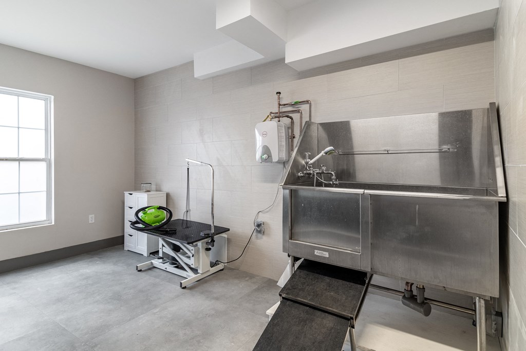 a large stainless steel sink in a room with a large window