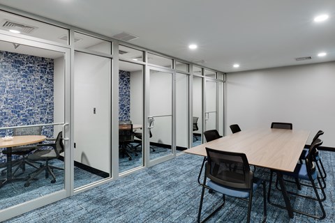 a meeting room with a table and chairs
