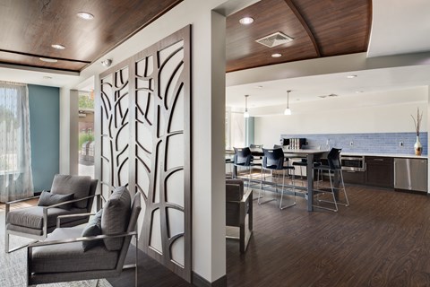 a living room with a kitchen in the background