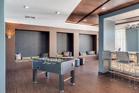 a games room with a foosball table and chairs