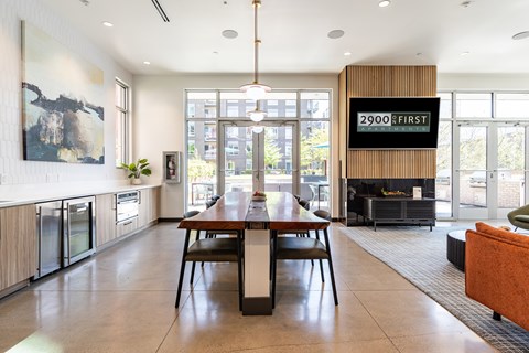 A modern kitchen with a dining table and chairs.