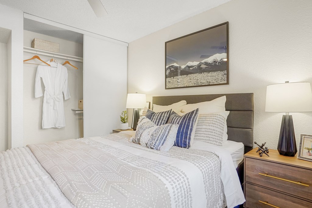 a bedroom with a large bed and a closet