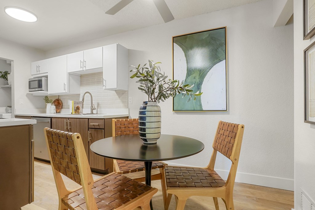 a kitchen and dining room with a table and chairs