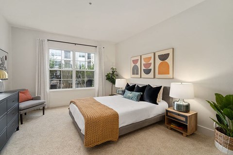 a bedroom with a bed and a window