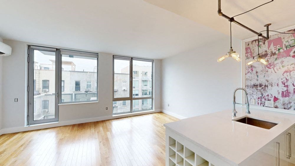 A kitchen with a white counter top and a sink.