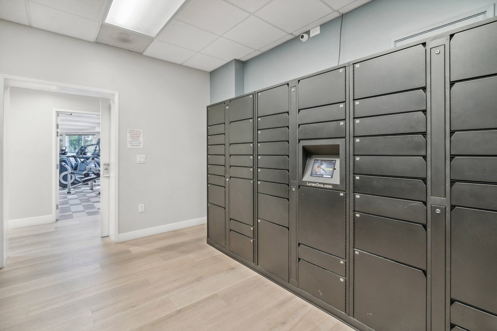 a set of industrial lockers in a room with a wooden floor