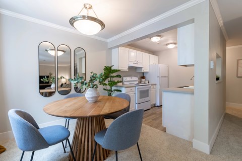 A modern dining area with a round table and chairs.