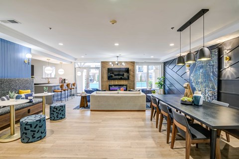 a living room and dining room with a table and chairs