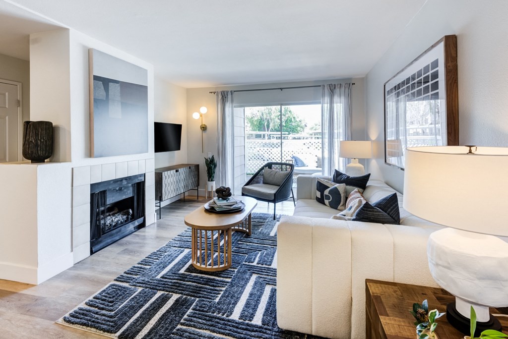 a living room with a fireplace and a large window