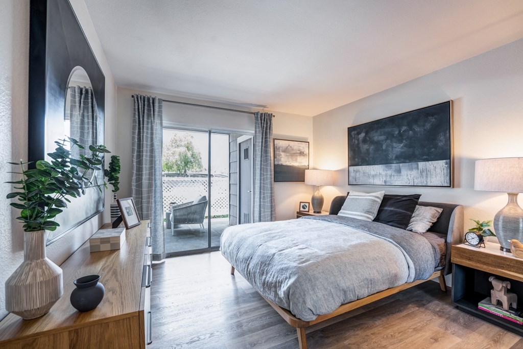 a bedroom with a large bed and a large window