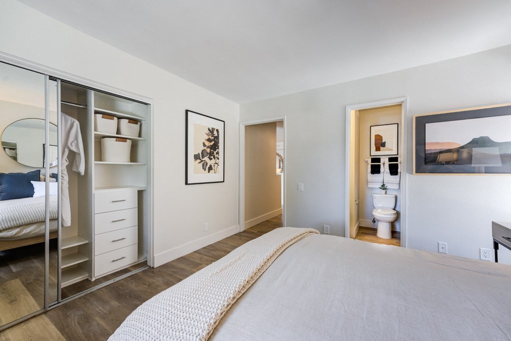 a bedroom with a bed and a mirror