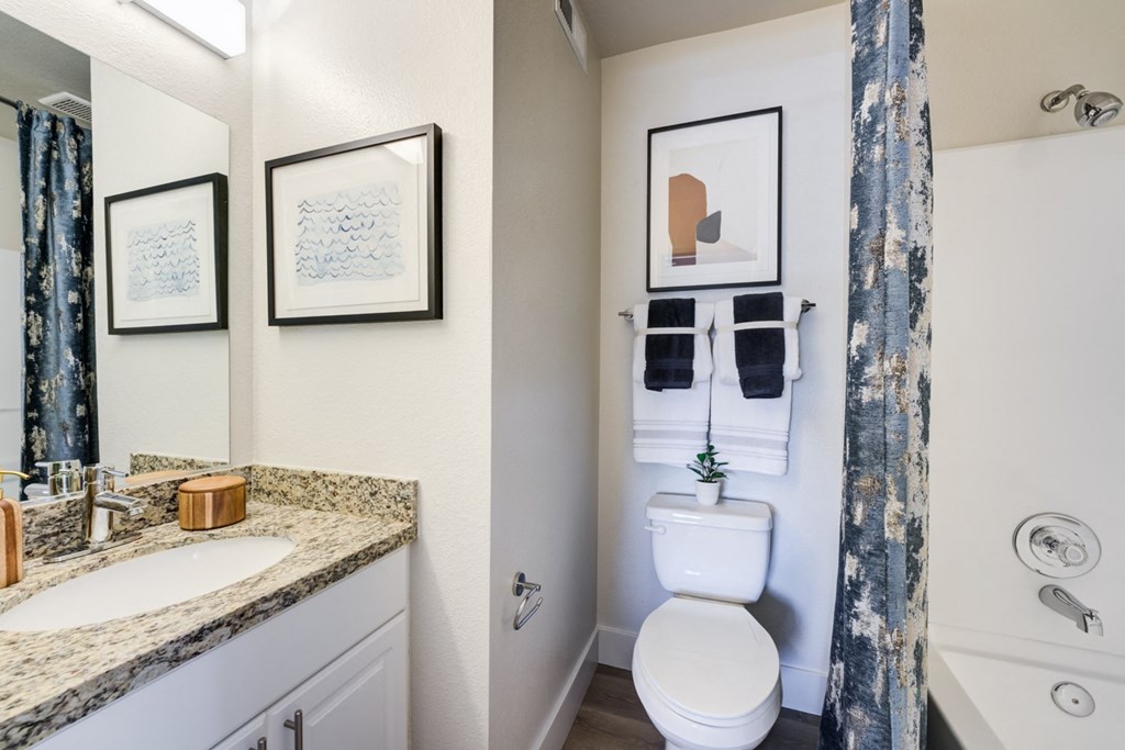 a bathroom with a toilet sink and bathtub
