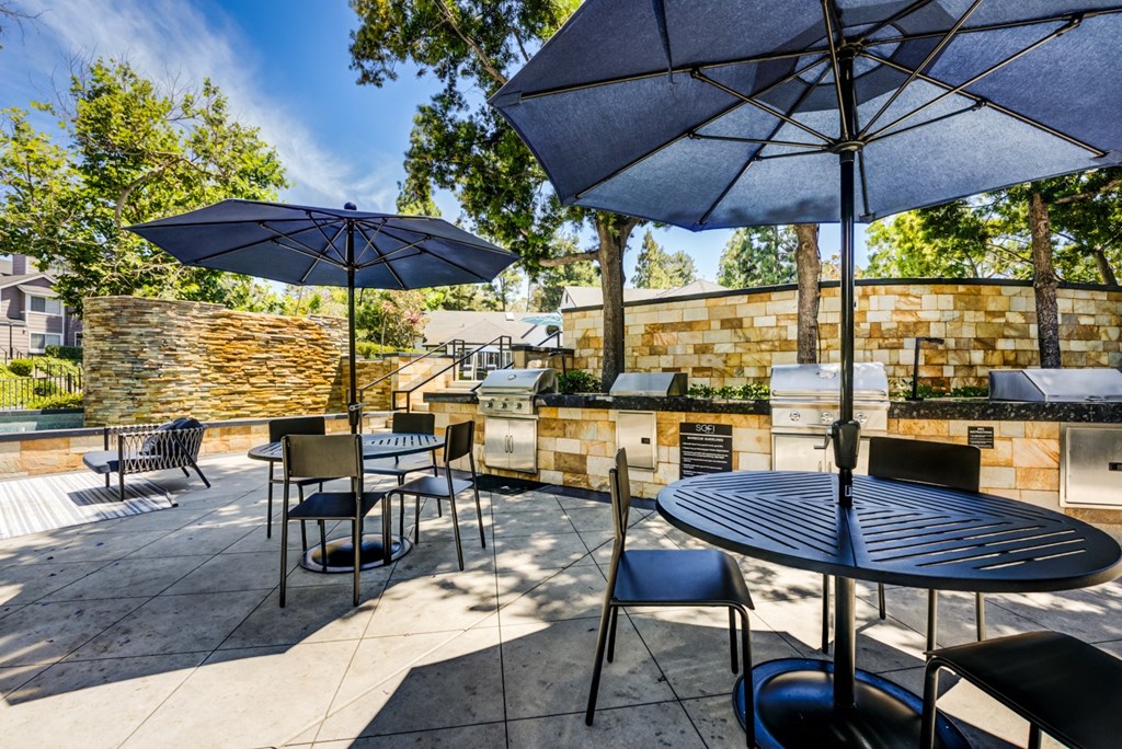 an outdoor patio with tables and umbrellas