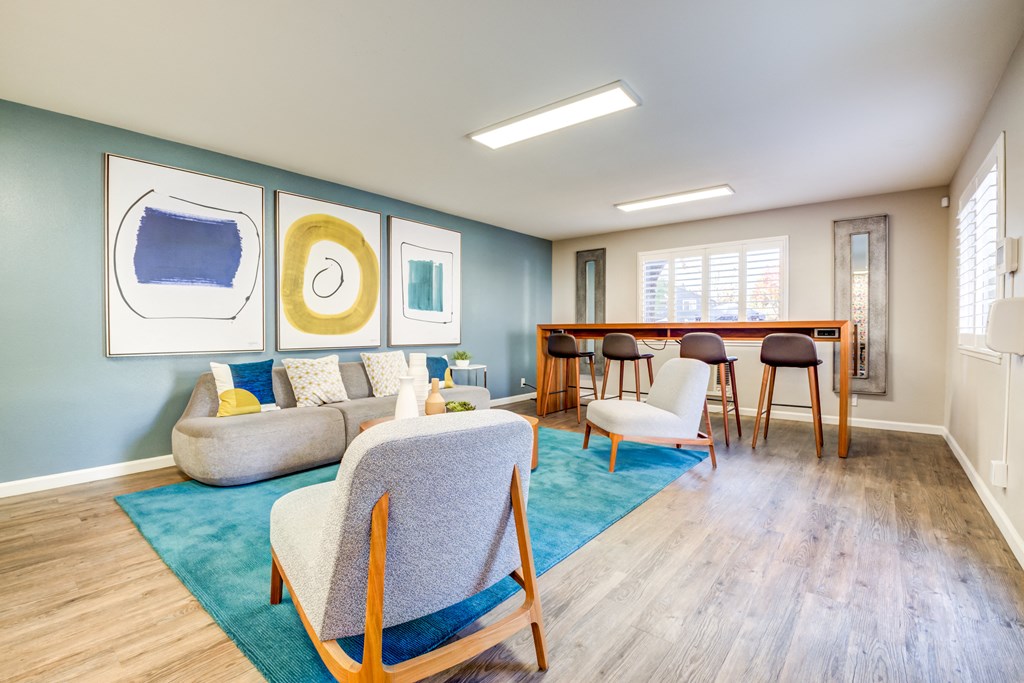a living room with a couch chairs and a table