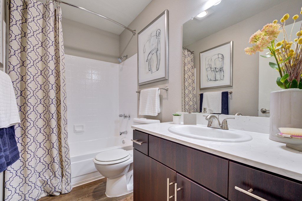a bathroom with a toilet sink and shower