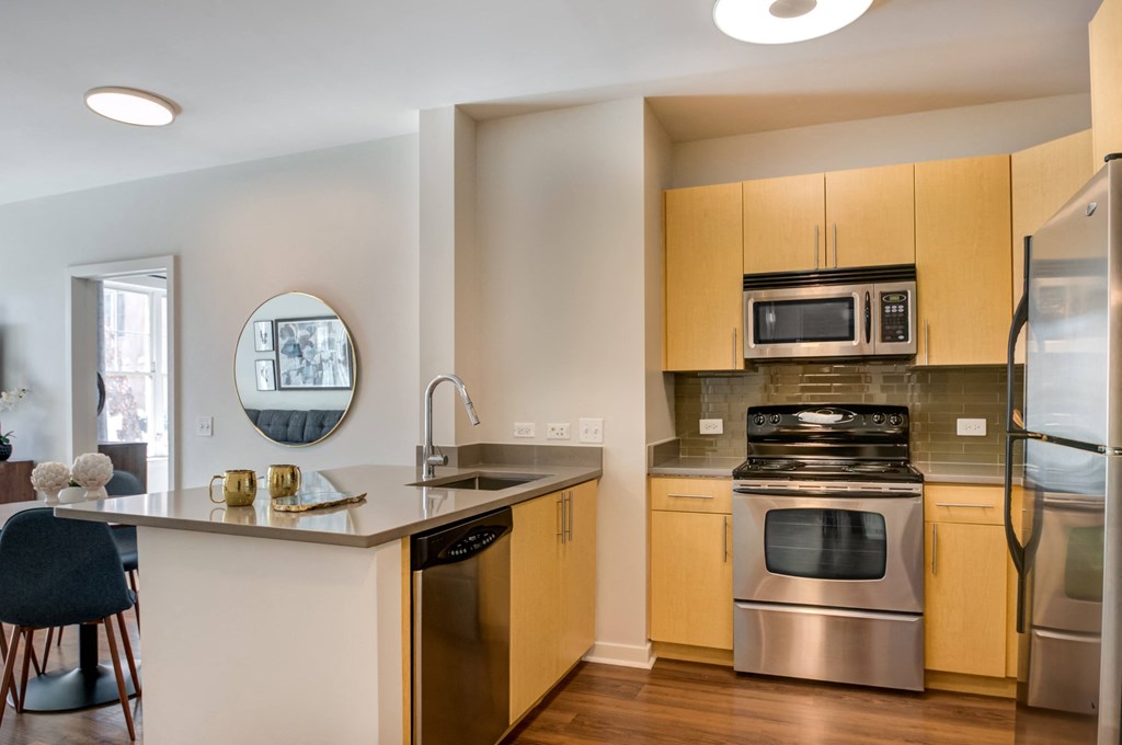 a kitchen with stainless steel appliances and wooden cabinets