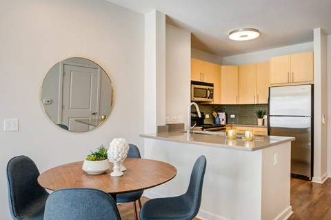 a kitchen and dining area with a round table and chairs