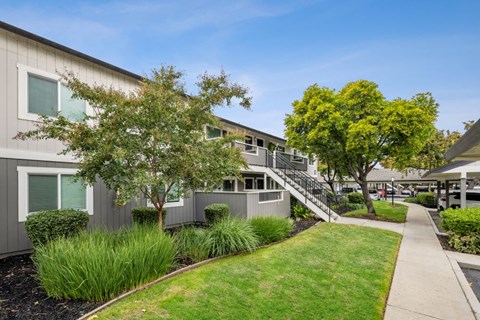A building with a grey exterior and a staircase leading to the second floor.