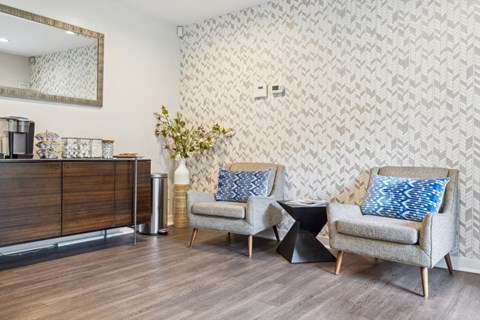A living room with a grey sofa and a wooden cabinet.