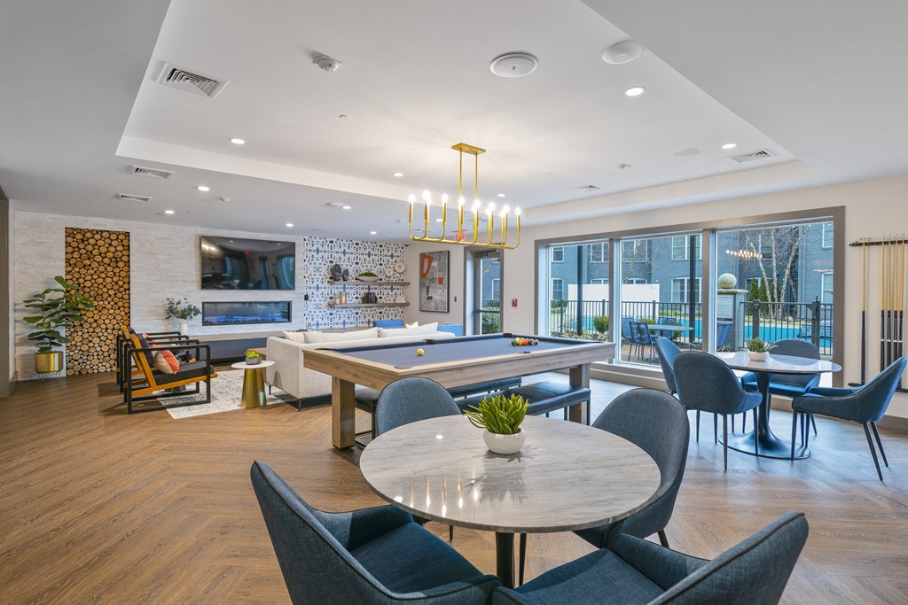 an open living room with a pool table and a dining area