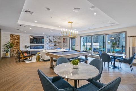 an open living room with a pool table and a dining area