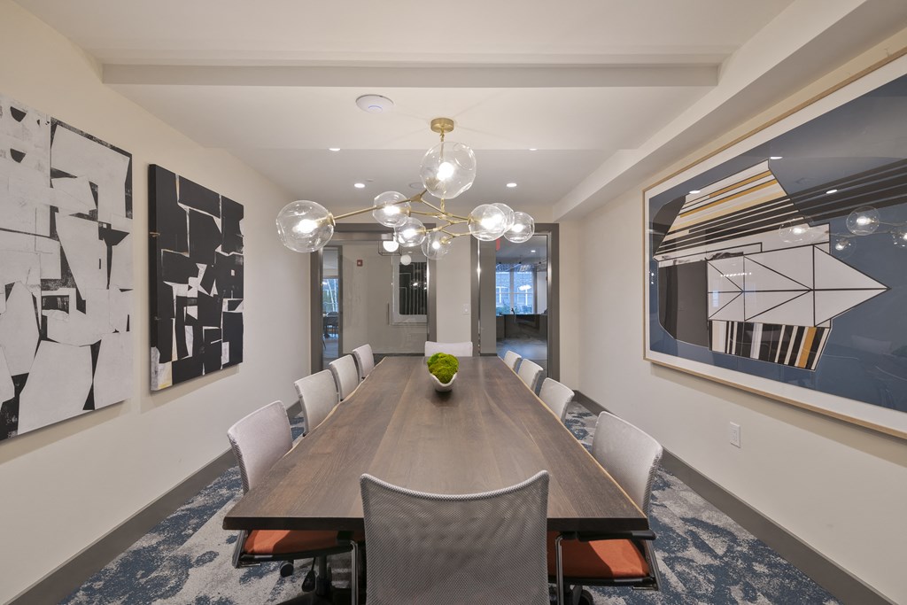 a dining room with a long table and chairs and a chandelier