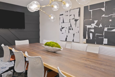 a dining room with a wooden table and white chairs