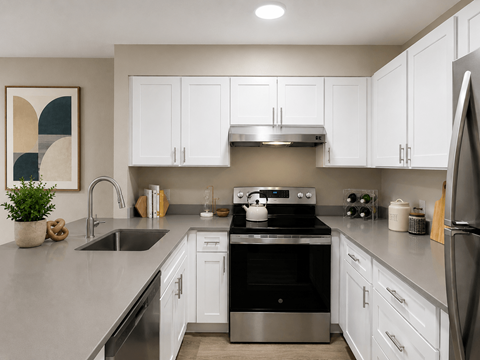 A modern kitchen with white cabinets and stainless steel appliances.